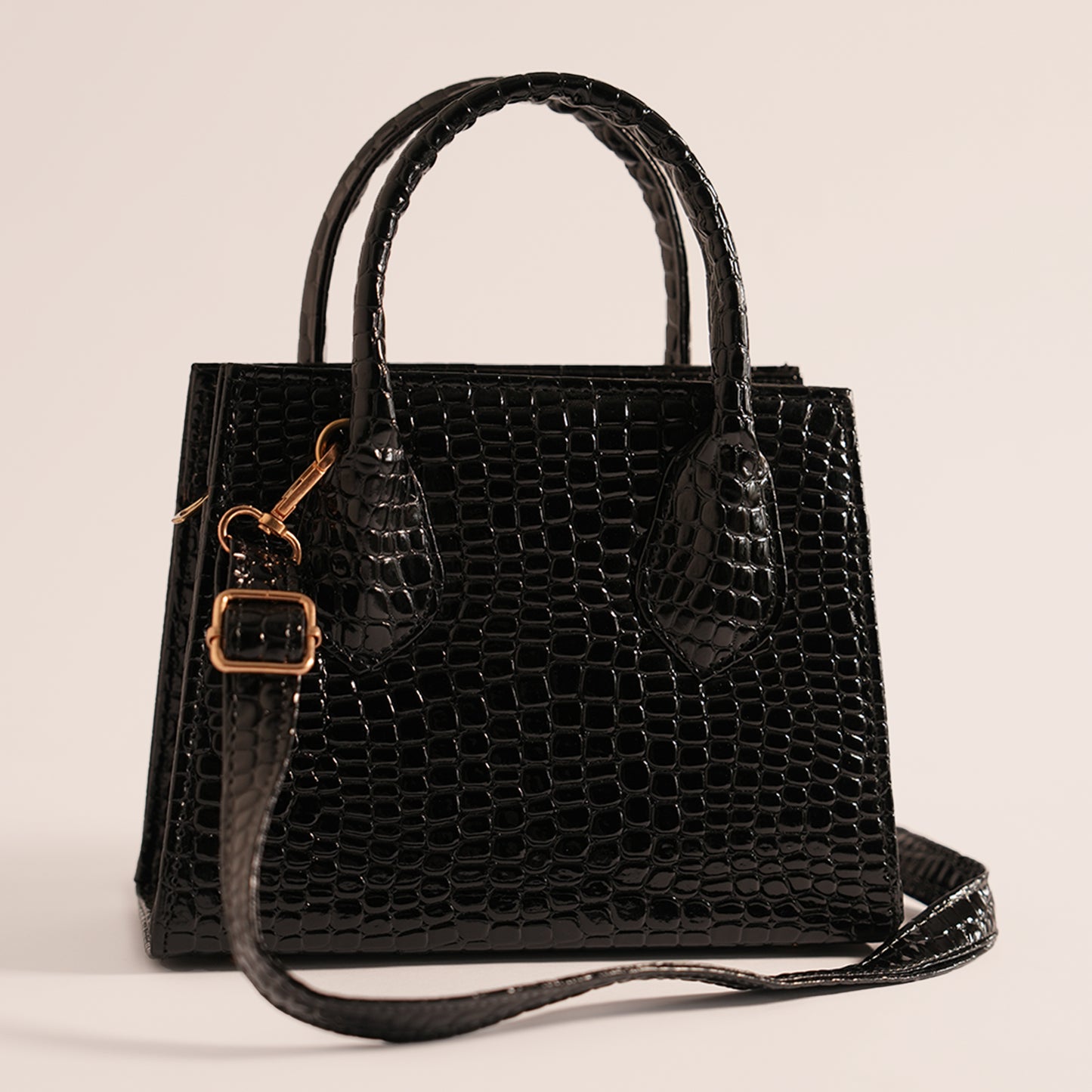 Close-up of Black Croc mini handbag’s adjustable strap