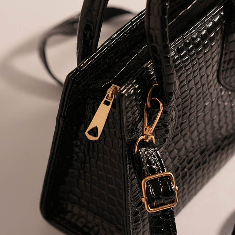 Close-up of Black Croc handbag’s adjustable strap